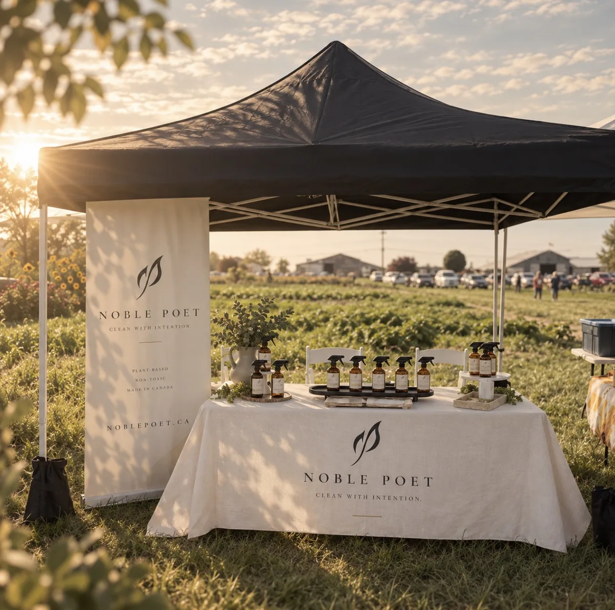 The Noble Poet market table and banner at golden hour at Westham Island Herb Farm